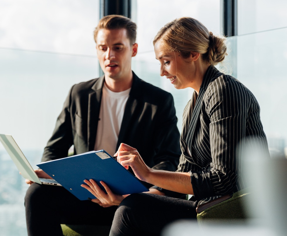 New York Life insurance agent and customer considering options together.